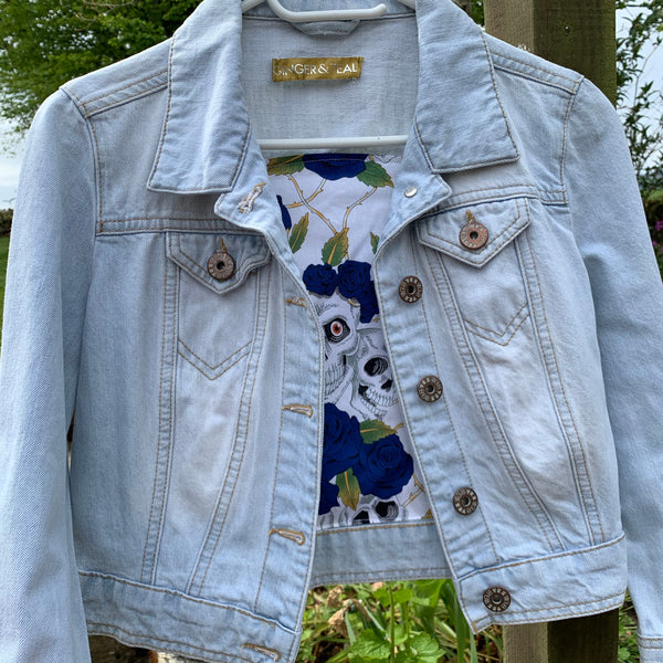 Denim jacket with drama mask embellishments