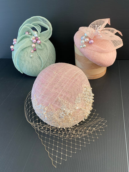 Nora - pale pink button fascinator  with crisp petal and multi colour pearl trim