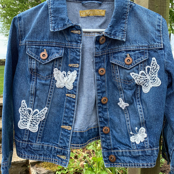 Denim jacket with butterfly embellishments