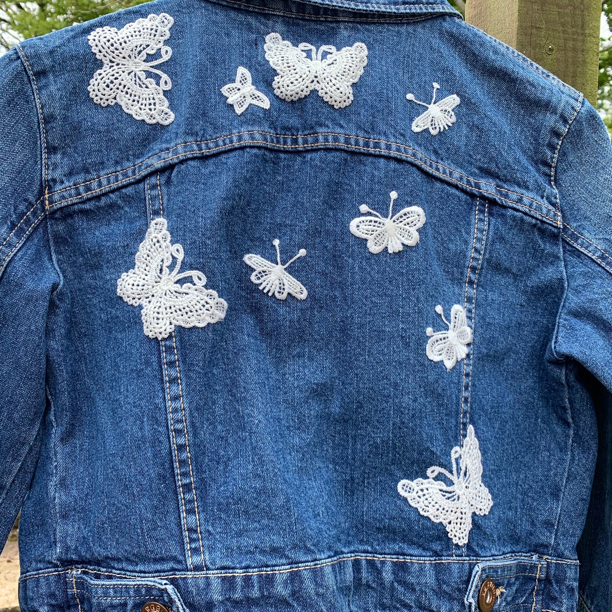 Denim jacket with butterfly embellishments