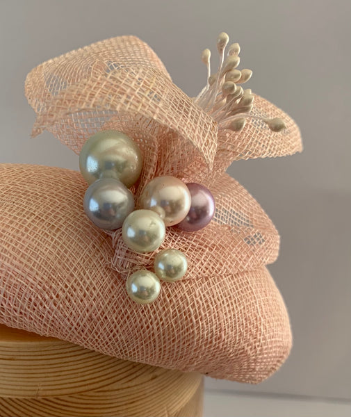 Nora - pale pink button fascinator  with crisp petal and multi colour pearl trim